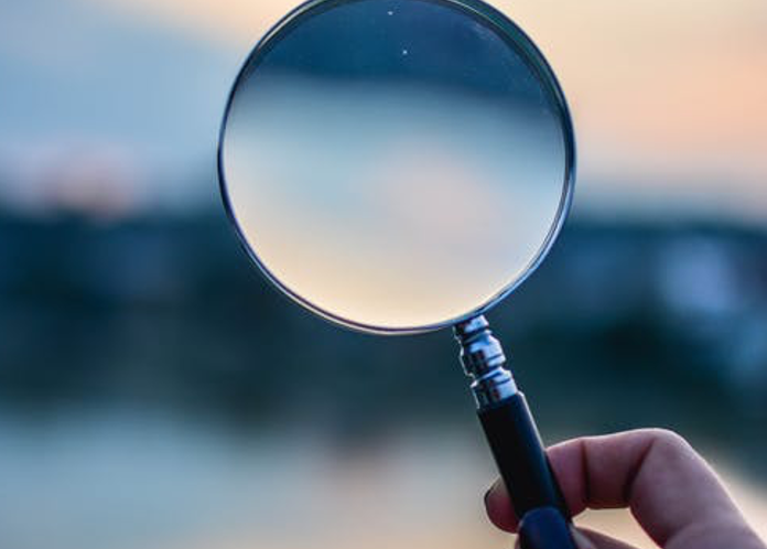 Woman holding magnifying glass