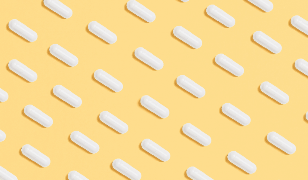 While pills on a yellow background aligned diagonally 